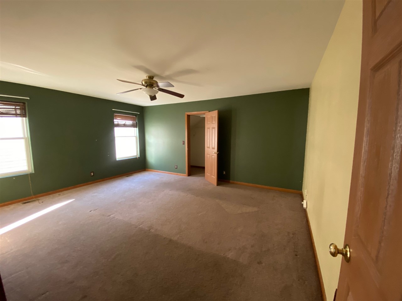 225 Market Street Genoa, IL 60135 - Photo 8 of 13 a view of a livingroom with a ceiling fan and window