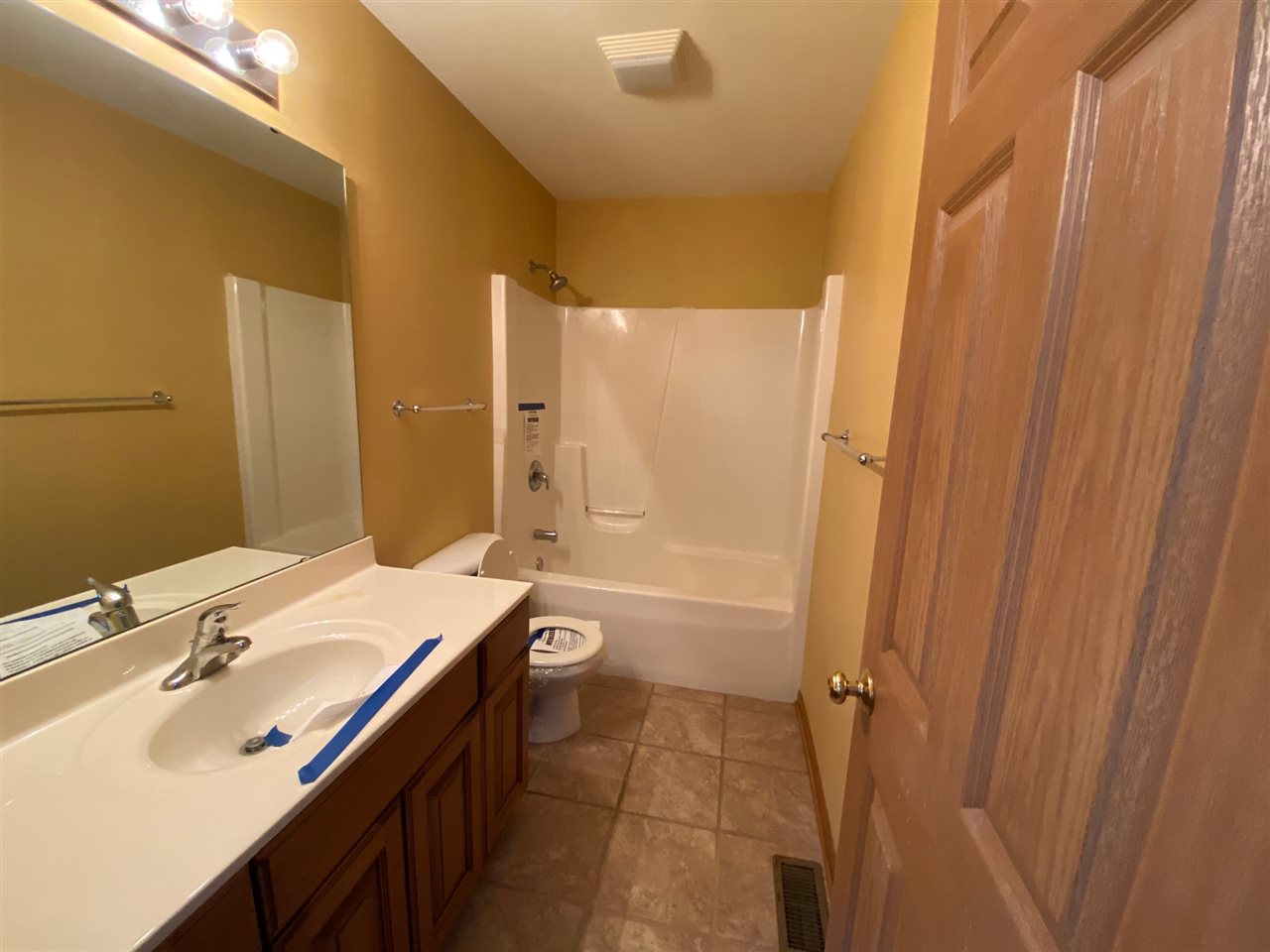 225 Market Street Genoa, IL 60135 - Photo 9 of 13 a bathroom with a sink a toilet and shower