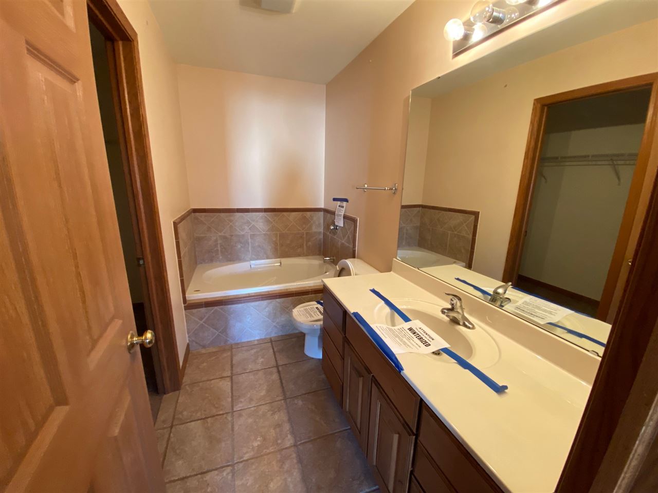 225 Market Street Genoa, IL 60135 - Photo 10 of 13 a bathroom with a sink a toilet and vanity