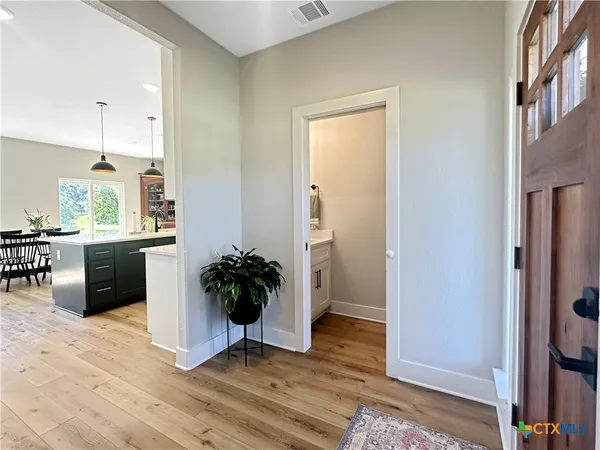 a kitchen with stainless steel appliances a refrigerator and a potted plant