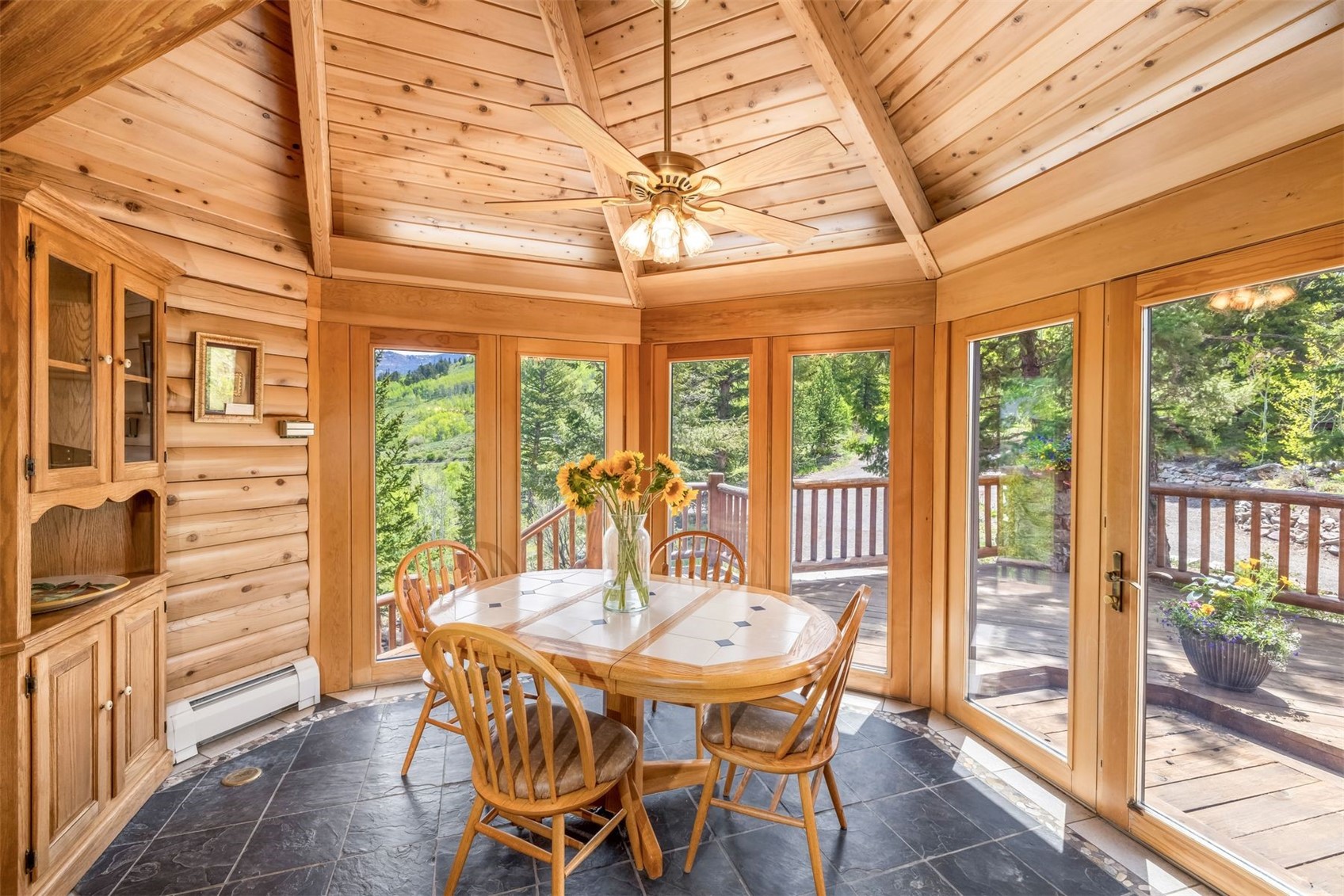 2244 Johnson Road Silverthorne, CO 80498 - Photo 15 of 50 a view of a dining room with furniture large windows and wooden floor