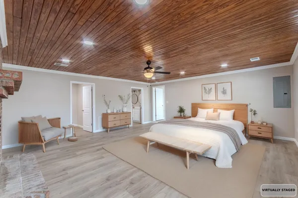 a spacious bedroom with a bed and glass walk in closet