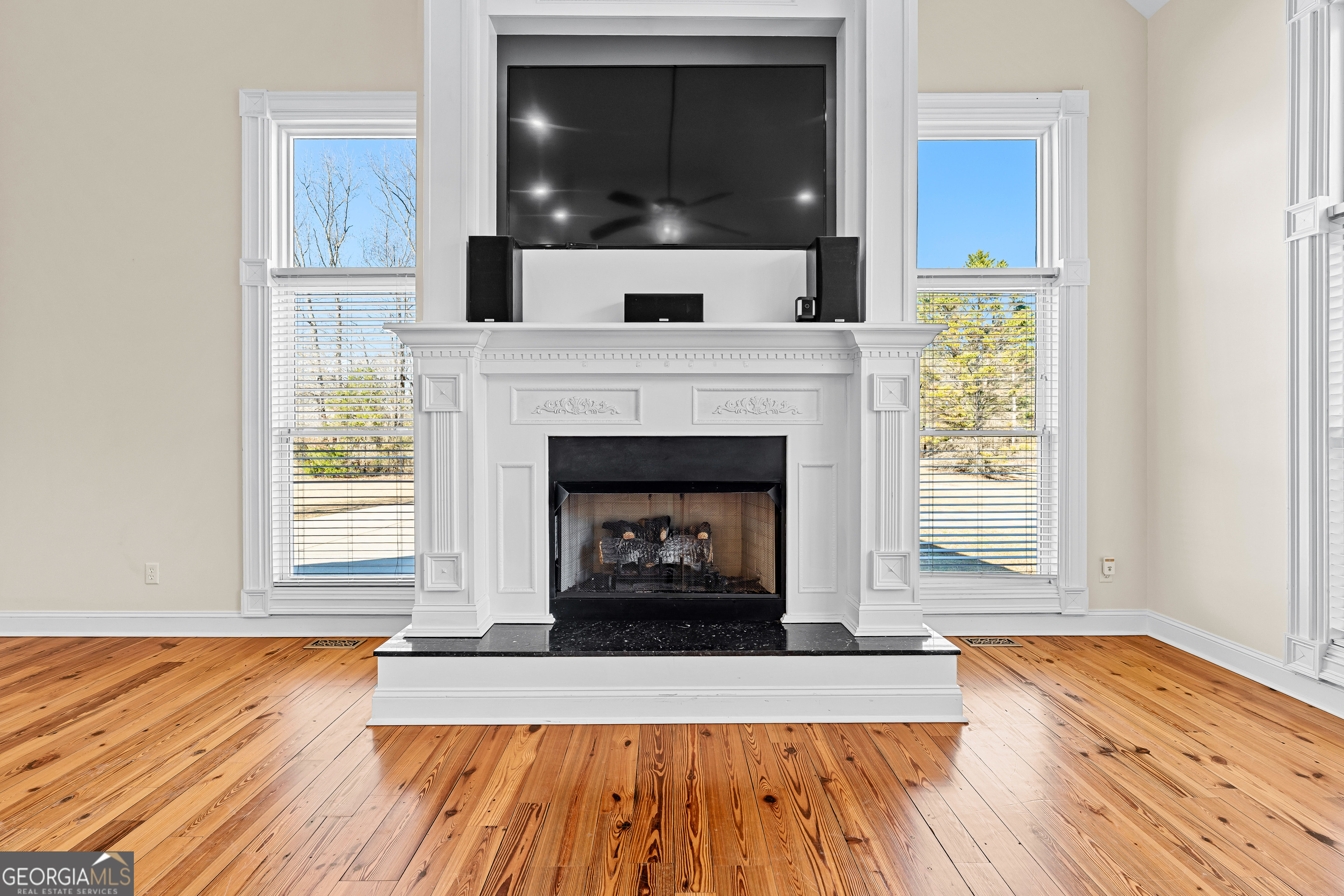 4101 West Ellis Road Griffin, GA 30223 - Photo 25 of 133 a living room with a fireplace and wooden floor