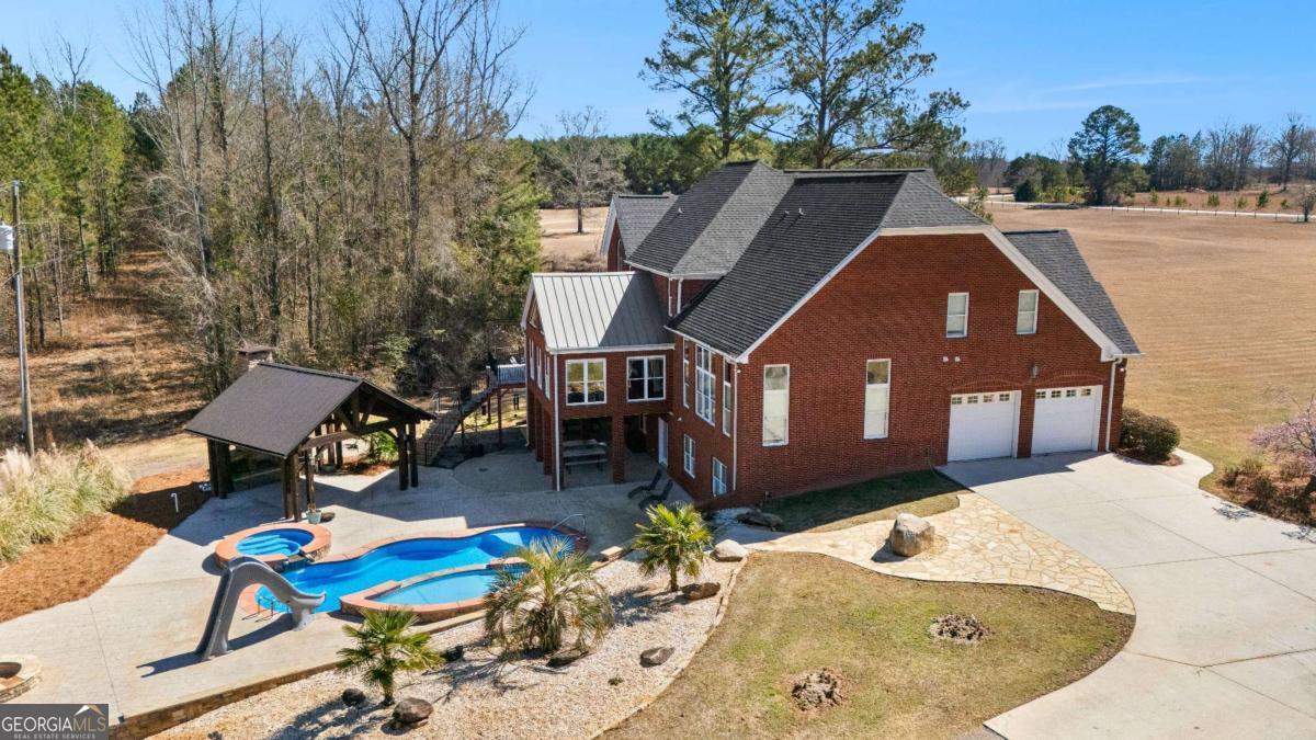 4101 West Ellis Road Griffin, GA 30223 - Photo 3 of 133 a view of a house with pool and chairs
