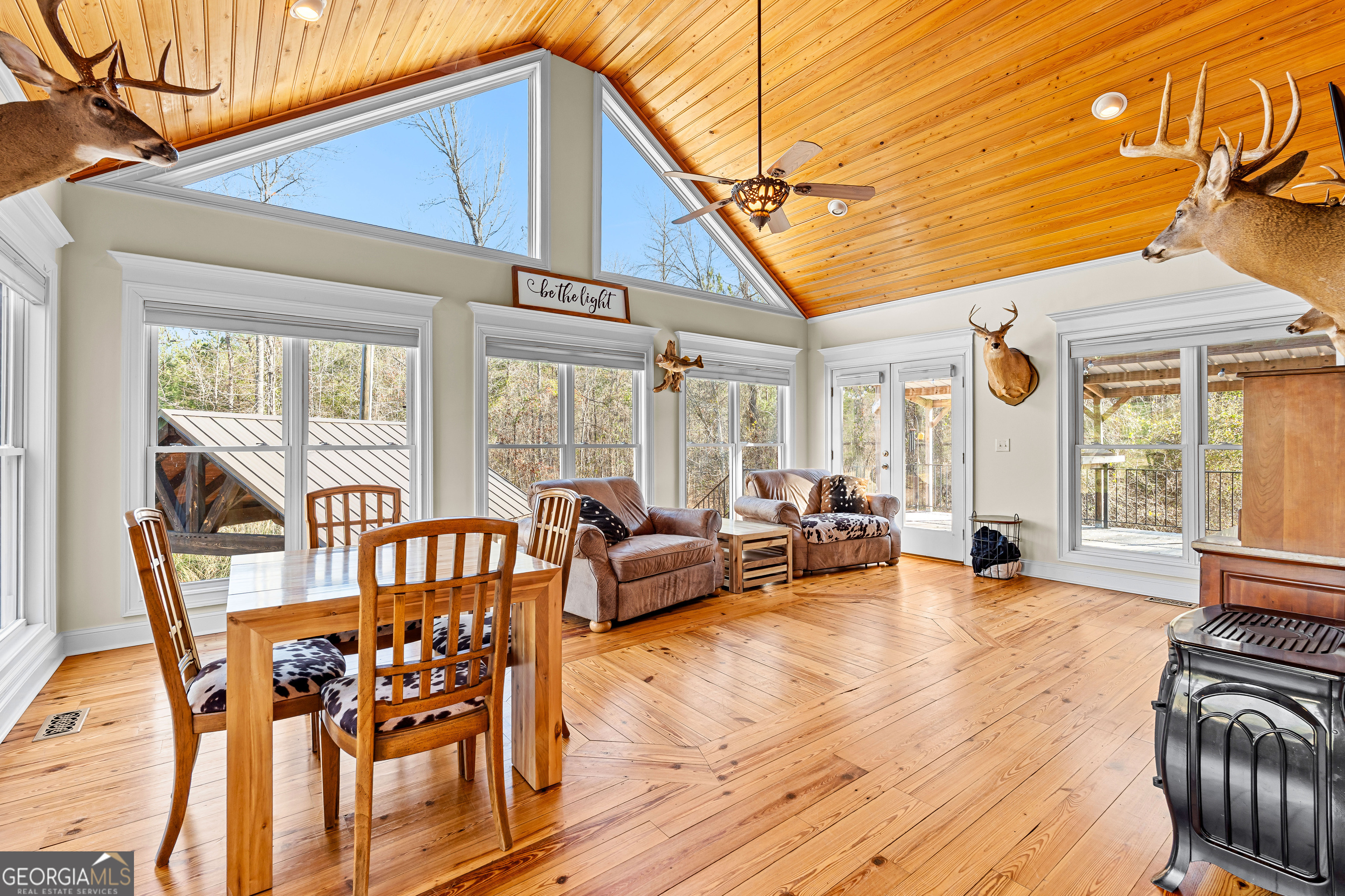 4101 West Ellis Road Griffin, GA 30223 - Photo 36 of 133 a view of a patio with dining table and chairs with wooden floor and fence