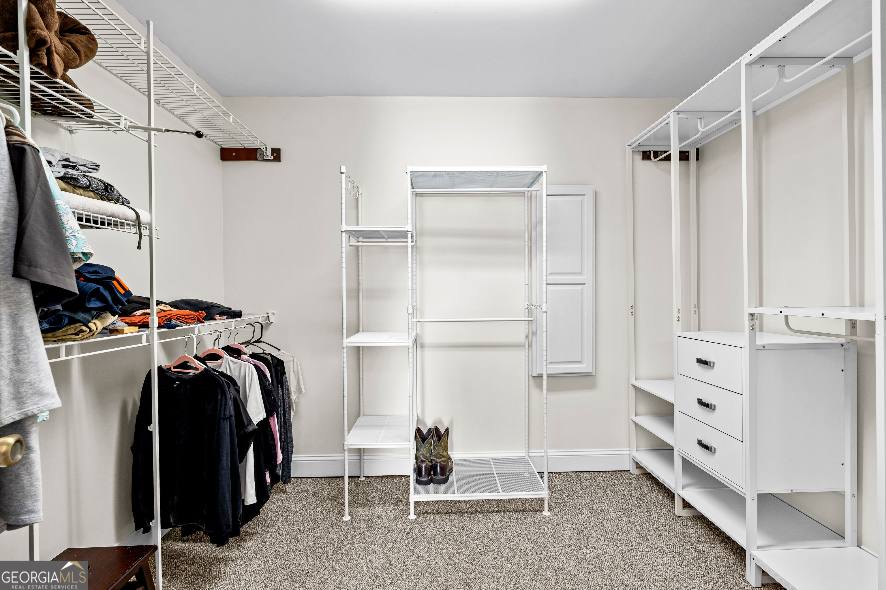 4101 West Ellis Road Griffin, GA 30223 - Photo 49 of 133 a view of walk in closet with clothes and shoes