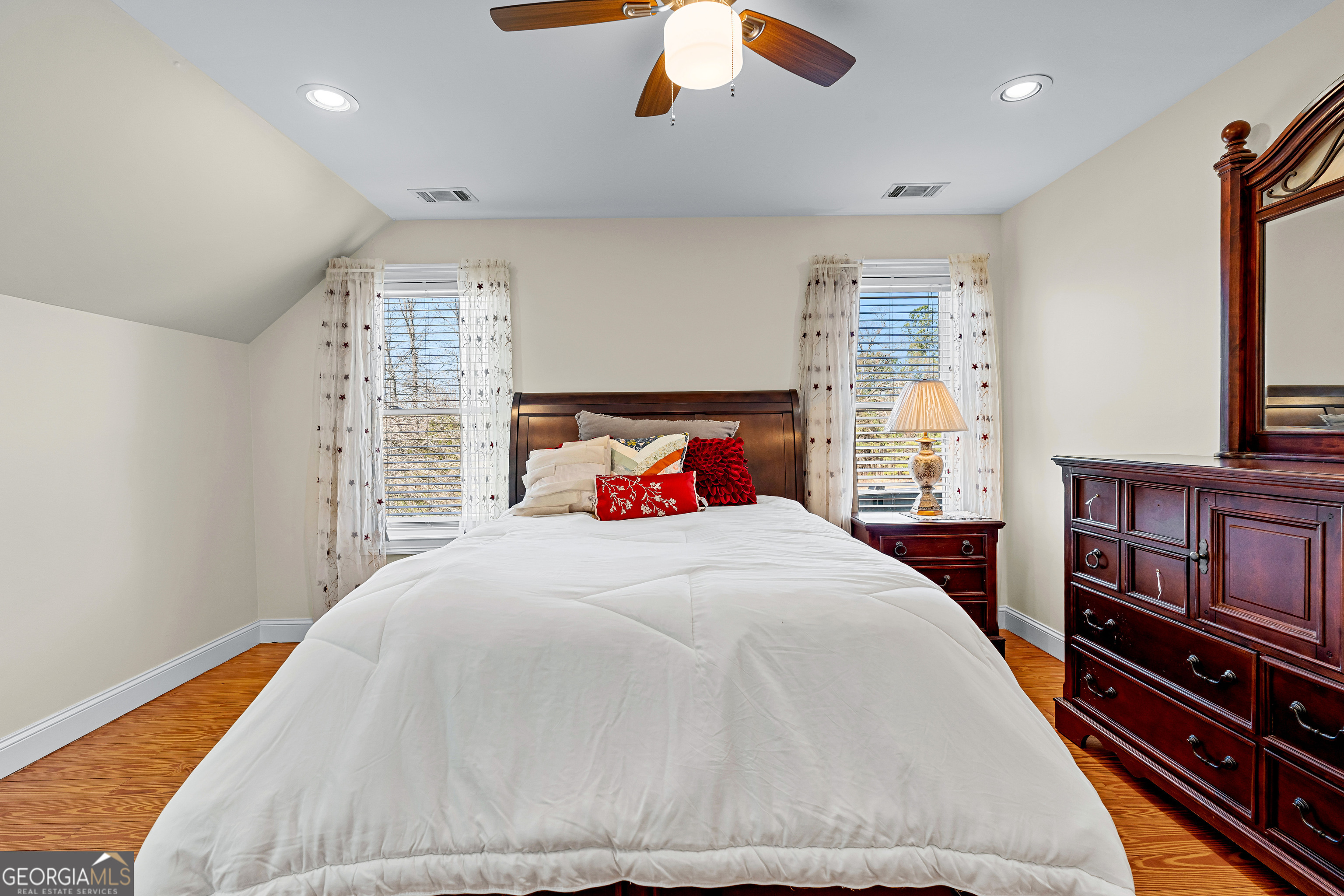 4101 West Ellis Road Griffin, GA 30223 - Photo 51 of 133 a bedroom with a large bed and a chandelier
