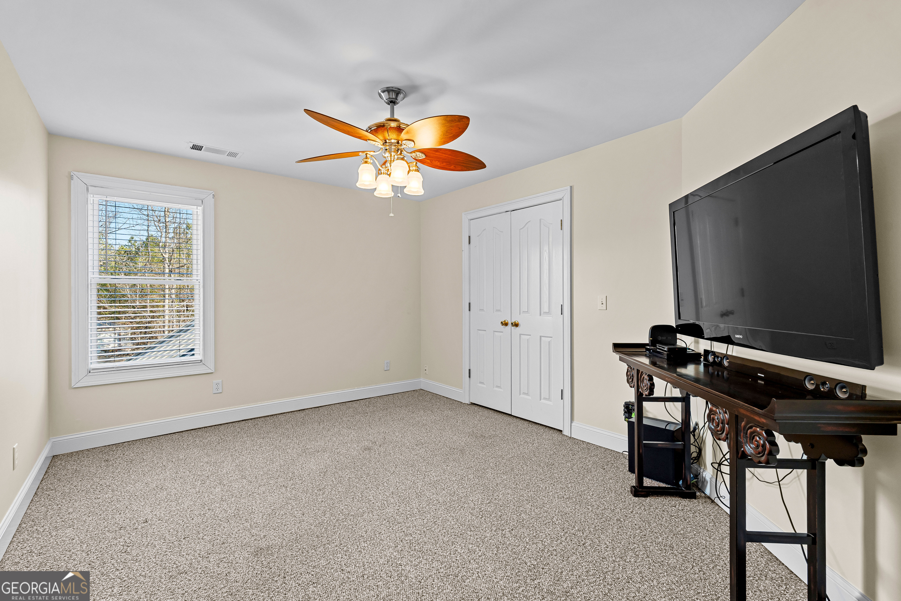 4101 West Ellis Road Griffin, GA 30223 - Photo 56 of 133 an empty room with windows wooden floor and a chandelier