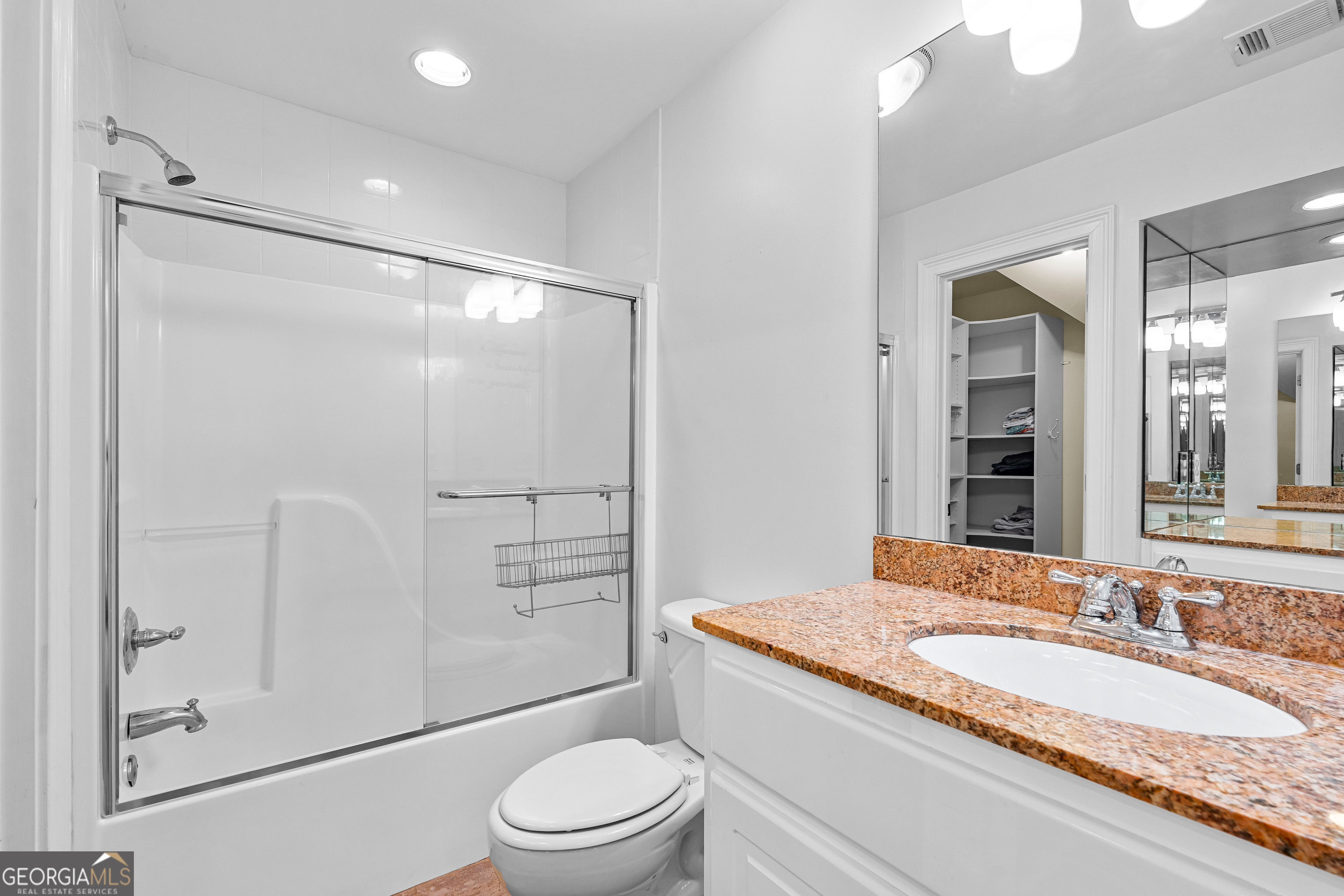 4101 West Ellis Road Griffin, GA 30223 - Photo 64 of 133 a bathroom with a granite countertop sink toilet mirror and shower