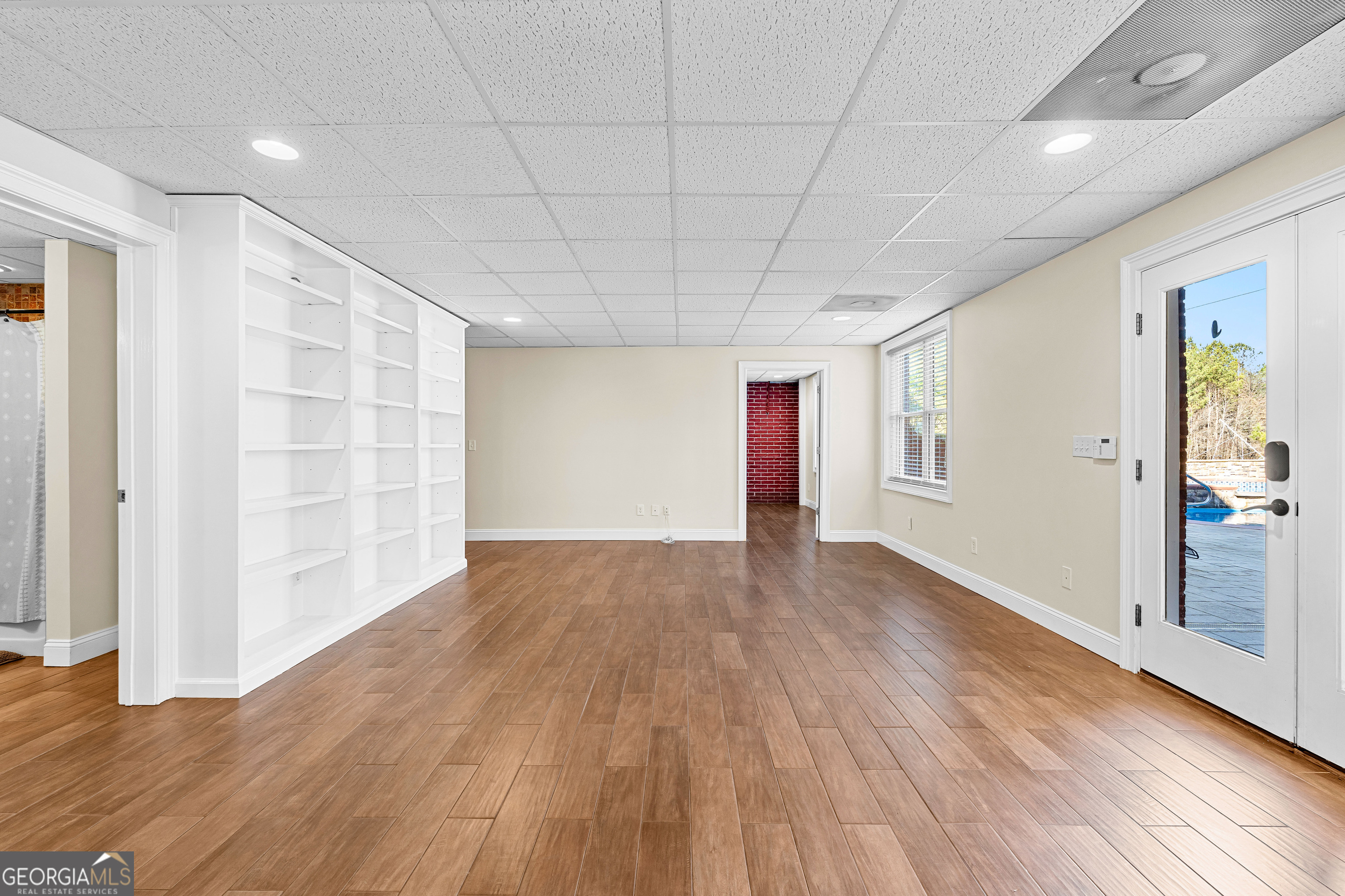 4101 West Ellis Road Griffin, GA 30223 - Photo 81 of 133 an empty room with wooden floor and windows