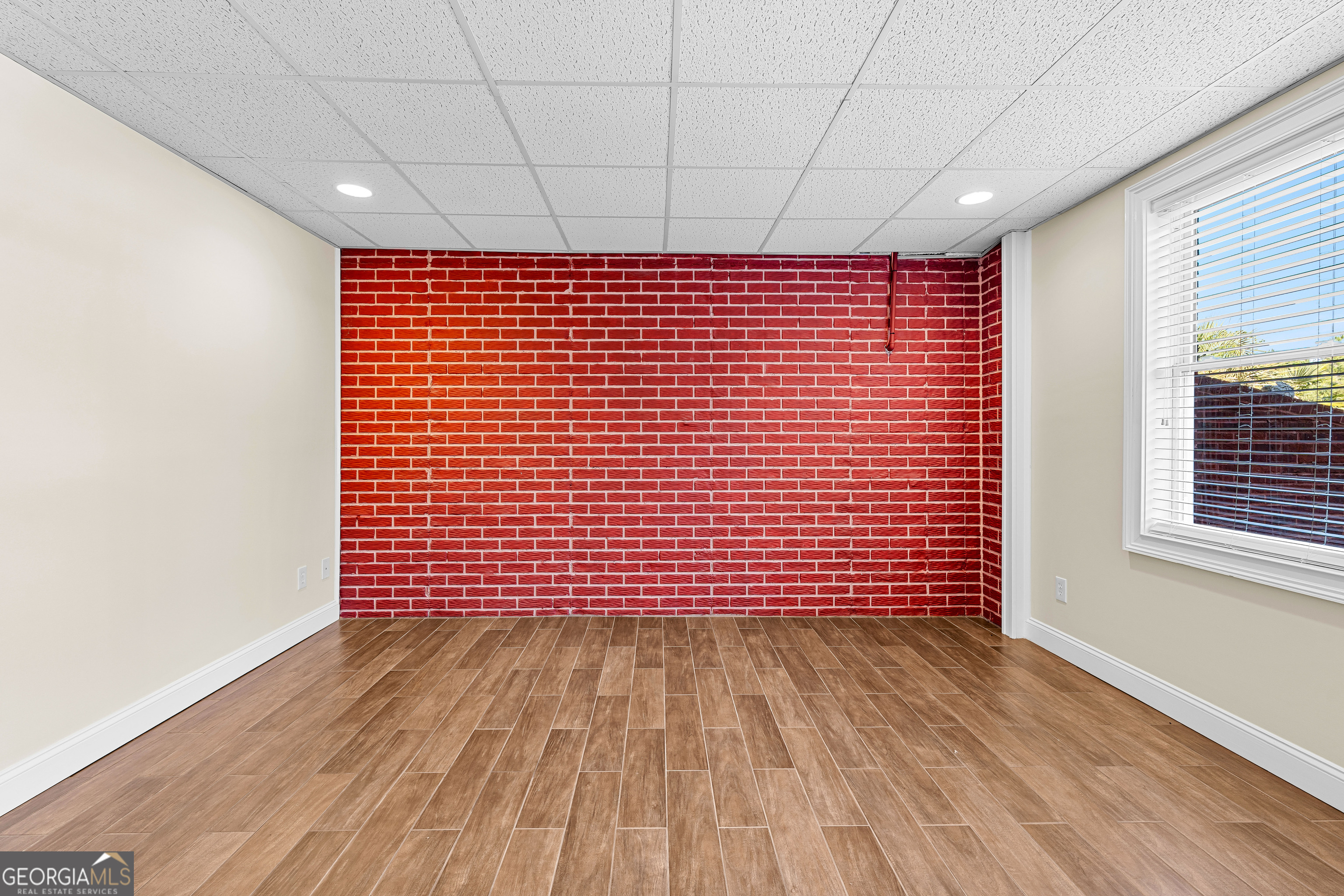 4101 West Ellis Road Griffin, GA 30223 - Photo 87 of 133 a view of empty room with wooden floor and fan