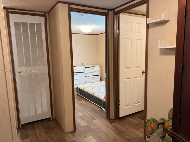 a view of bedroom with a bed and wooden floor