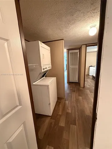 a view of a hallway with wooden floor and stairs