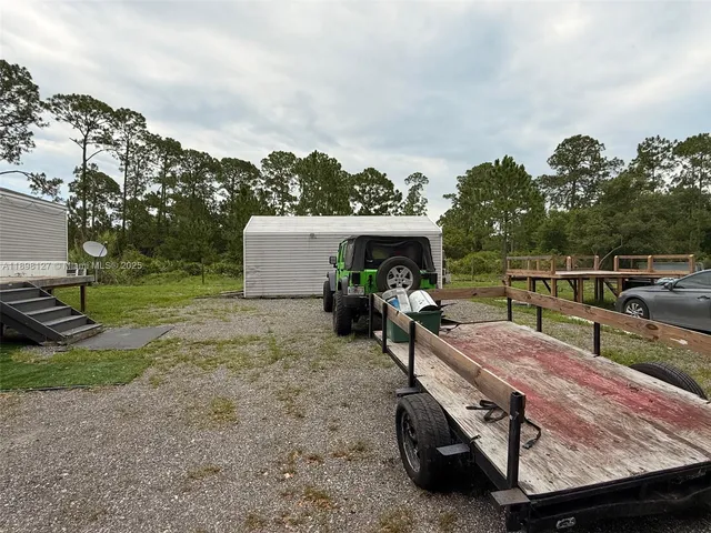 a view of a patio with table and chairs a barbeque with wooden fence