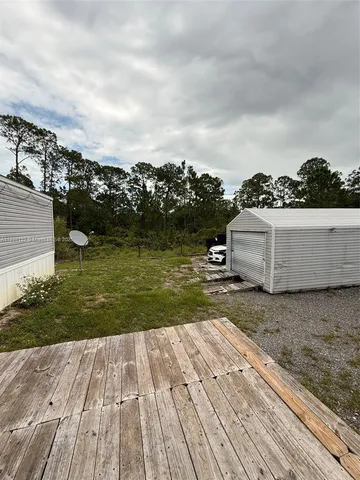 a view of a backyard with table and chairs