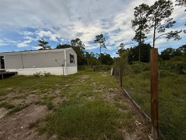 a view of field with trees in the background