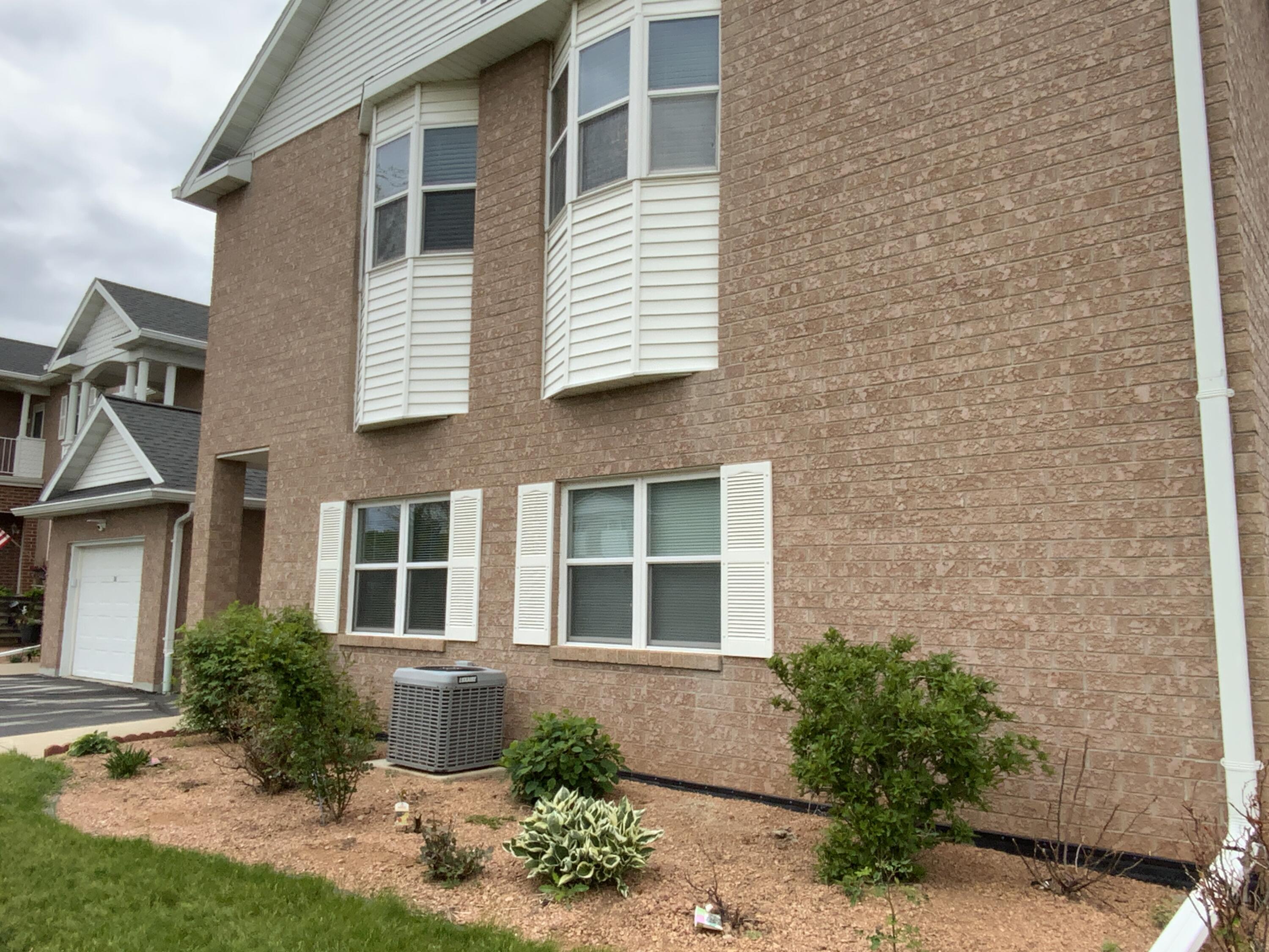 1807 Ridgeway Drive, Unit 38 De Pere, WI 54115 - Photo 35 of 39 front of condo with rose bushes