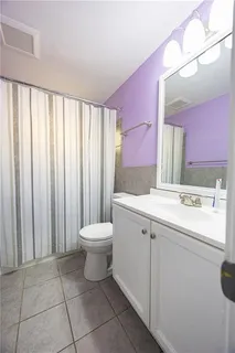 a bathroom with a sink a toilet and mirror