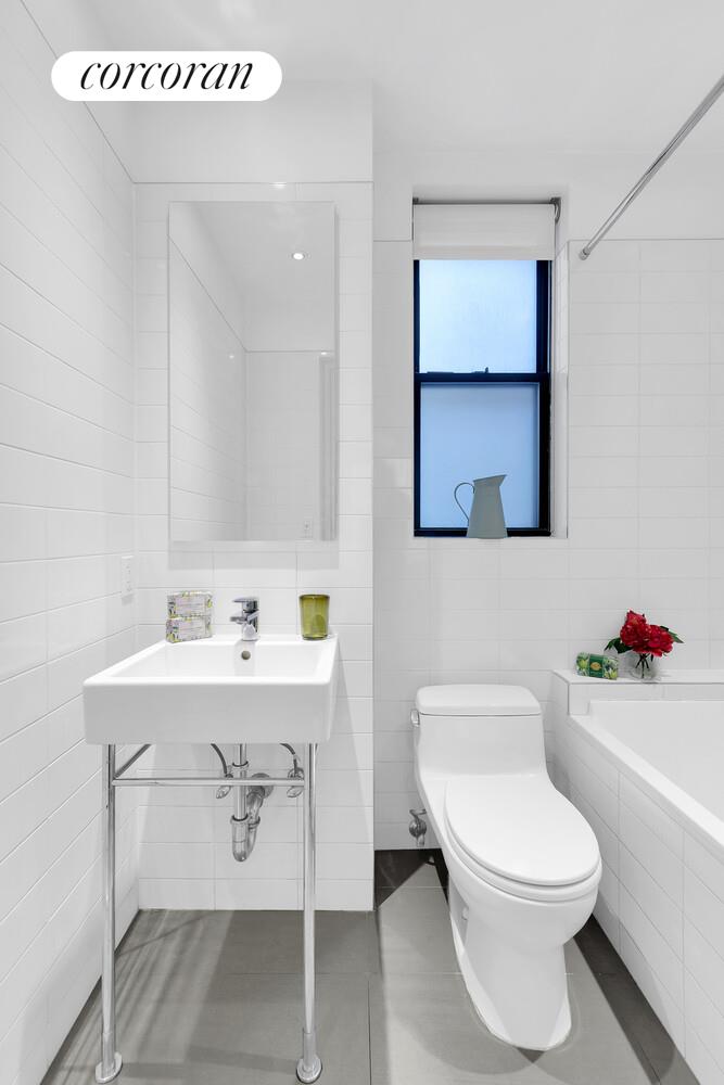 175 East 79th Street, Unit 2C Manhattan, NY 10075 - Photo 11 of 17 a white toilet sitting next to a bathroom sink