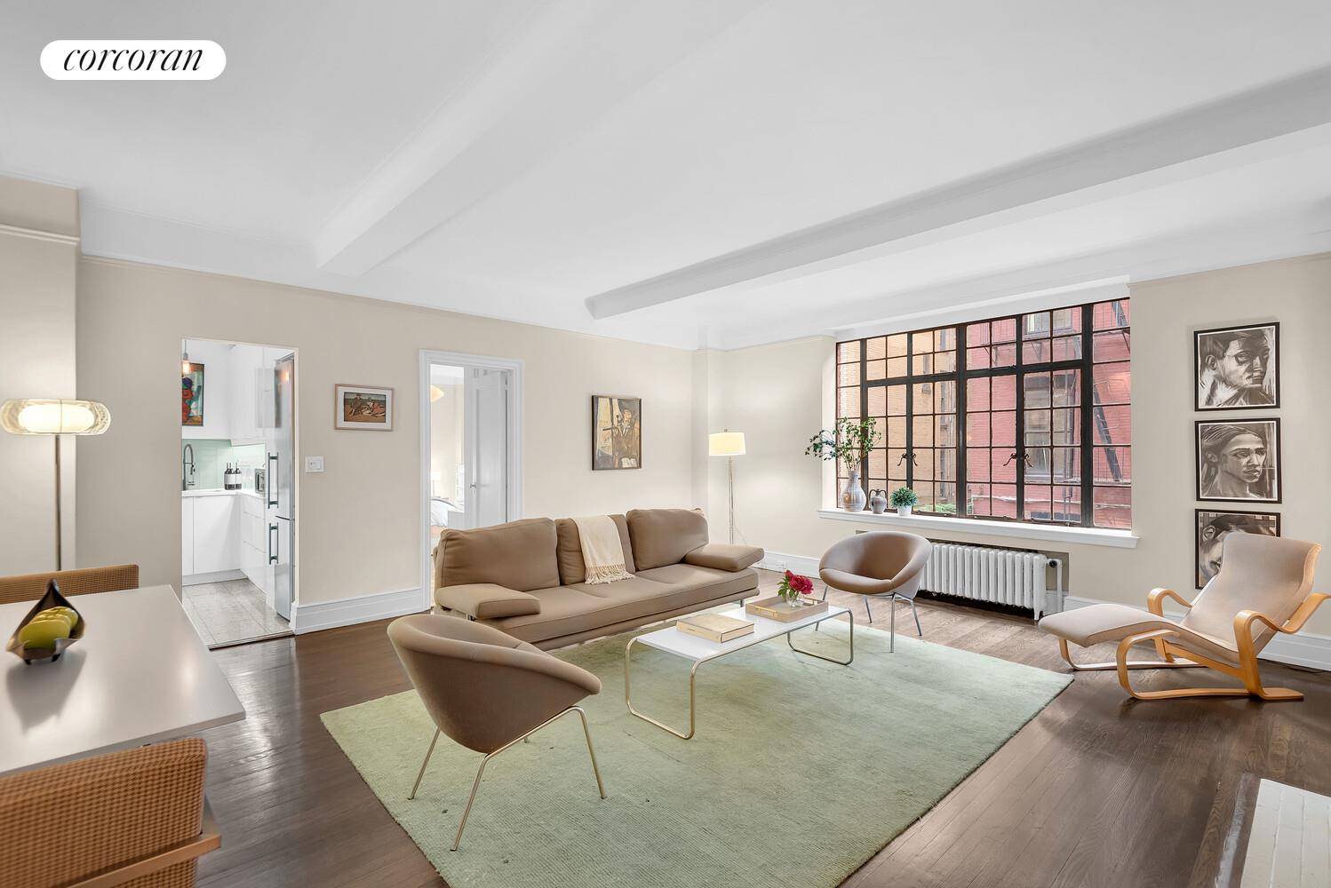 175 East 79th Street, Unit 2C Manhattan, NY 10075 - Photo 5 of 17 a living room with furniture and large windows