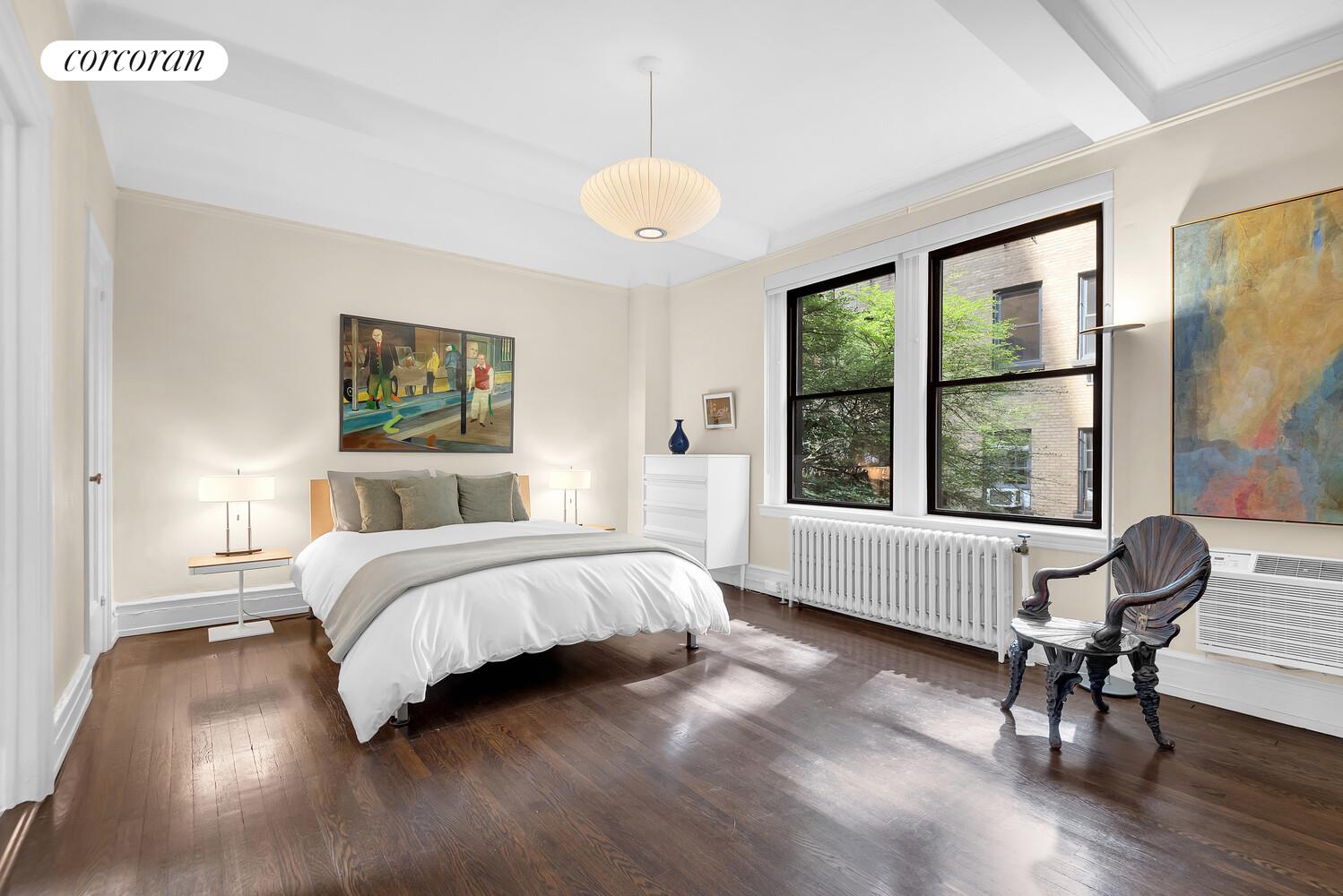 175 East 79th Street, Unit 2C Manhattan, NY 10075 - Photo 8 of 17 a bedroom with a bed and a large window