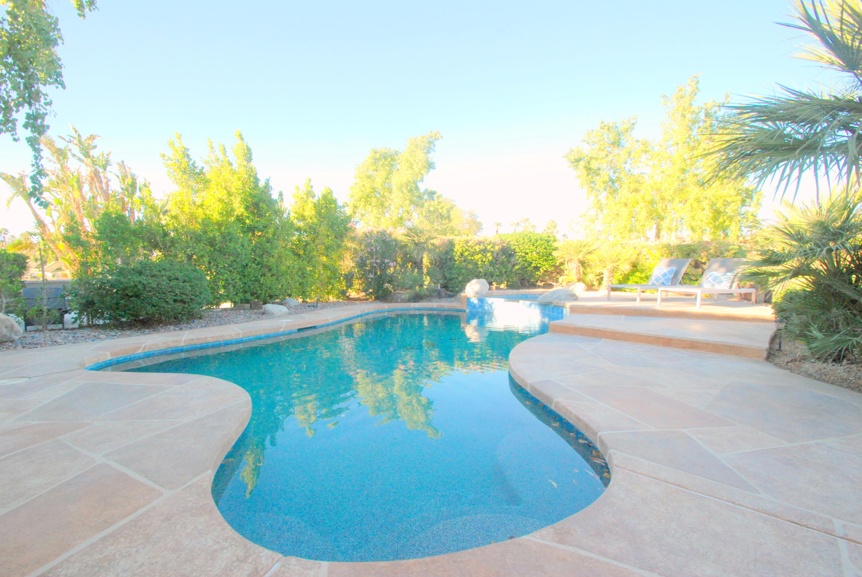 22 Pebble Beach Drive Rancho Mirage, CA 92270 - Photo 2 of 10 a view of a swimming pool with an outdoor seating