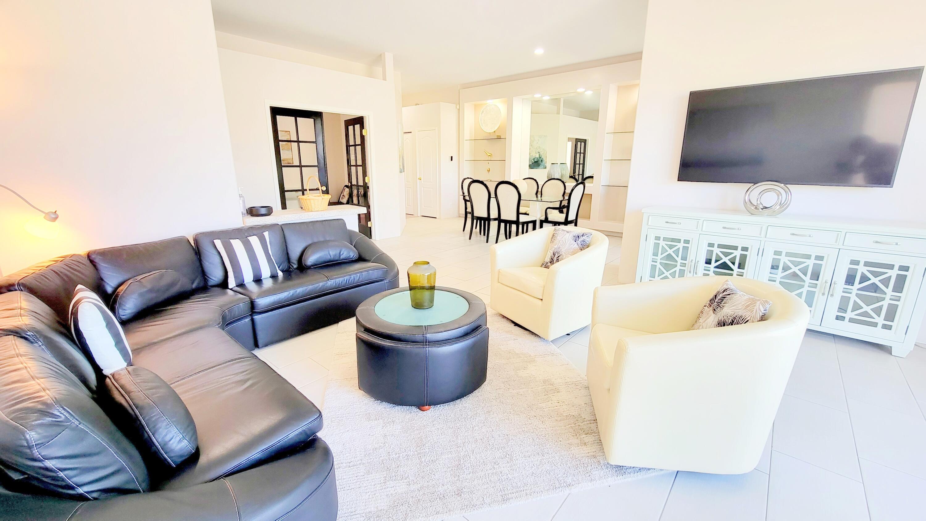 22 Pebble Beach Drive Rancho Mirage, CA 92270 - Photo 5 of 10 a living room with furniture and a flat screen tv