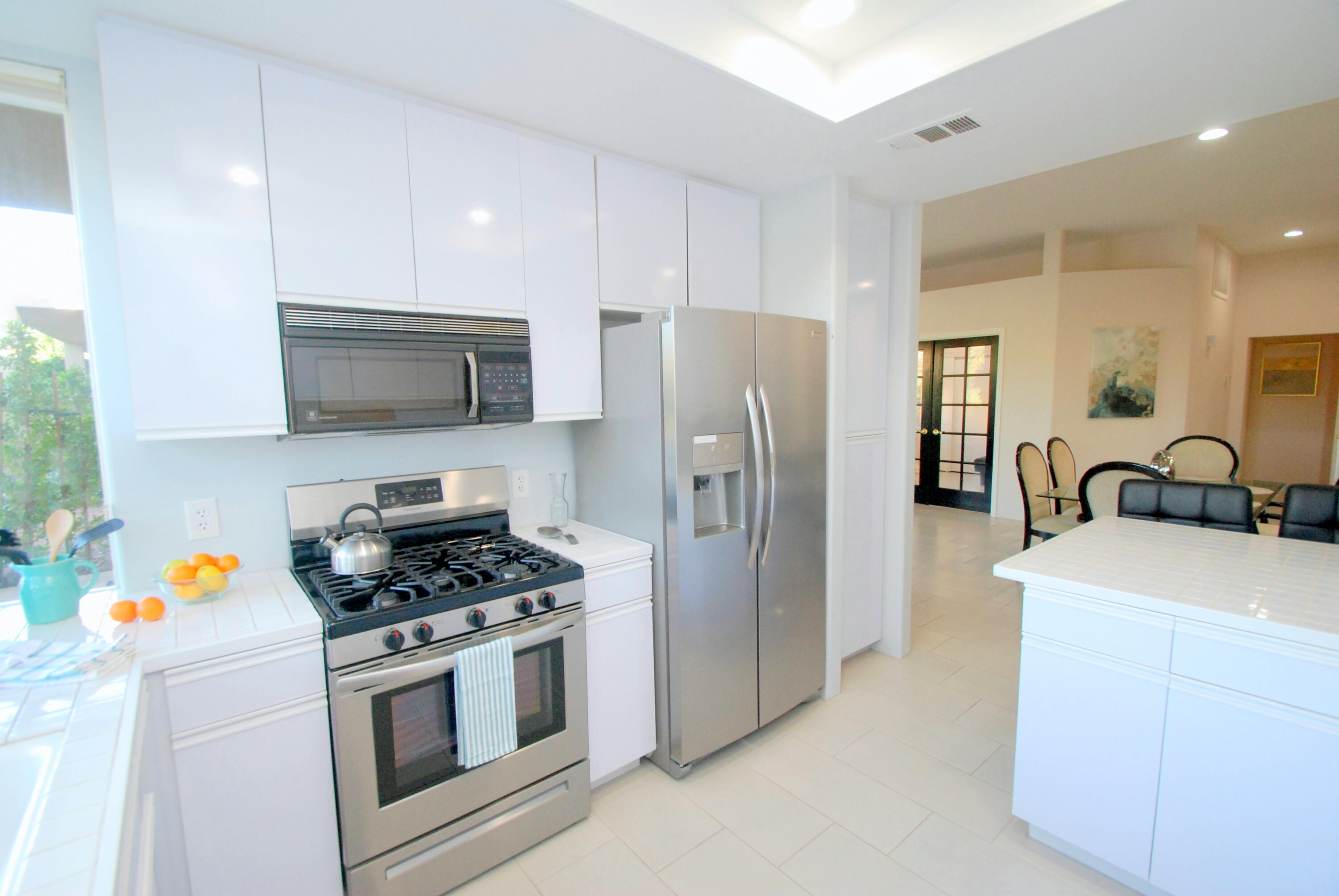 22 Pebble Beach Drive Rancho Mirage, CA 92270 - Photo 8 of 10 a kitchen with stainless steel appliances a refrigerator stove microwave and sink