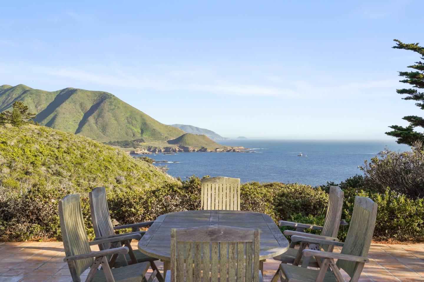 31541 Highway 1 Carmel, CA 93923 - Photo 1 of 73 a view of a terrace with a table and chairs under an umbrella