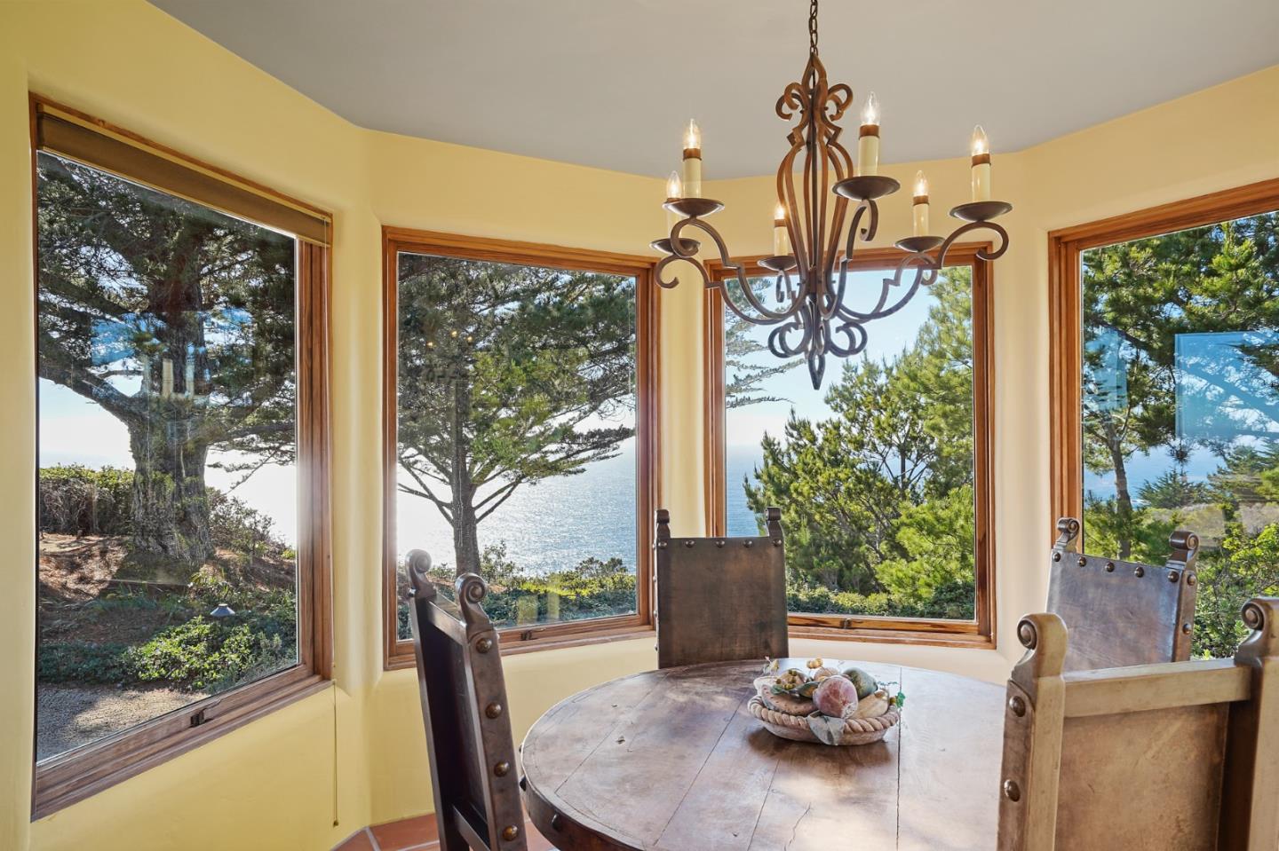31541 Highway 1 Carmel, CA 93923 - Photo 24 of 73 a view of a dining room with furniture water view and a floor to ceiling window