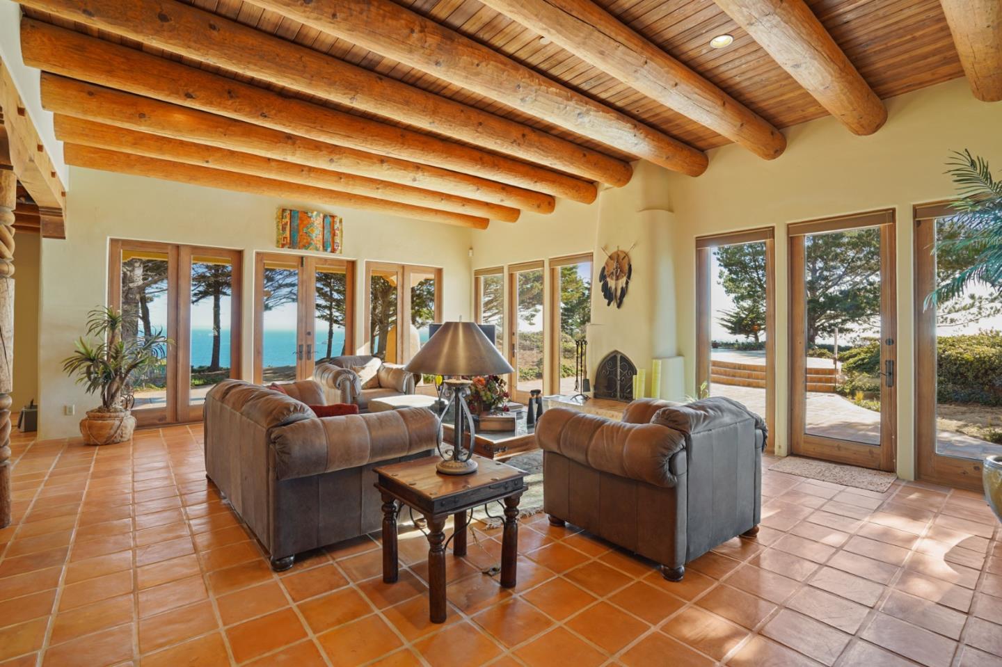 31541 Highway 1 Carmel, CA 93923 - Photo 28 of 73 a living room with fireplace furniture and a floor to ceiling window
