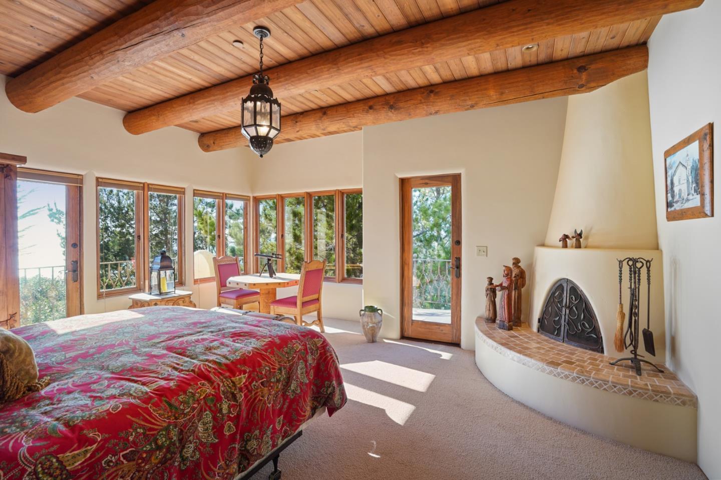 31541 Highway 1 Carmel, CA 93923 - Photo 35 of 73 a bedroom with a bed a fireplace and a large window