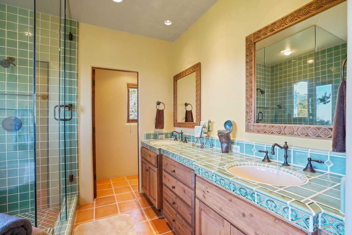 31541 Highway 1 Carmel, CA 93923 - Photo 42 of 73 a bathroom with a granite countertop sink and a mirror