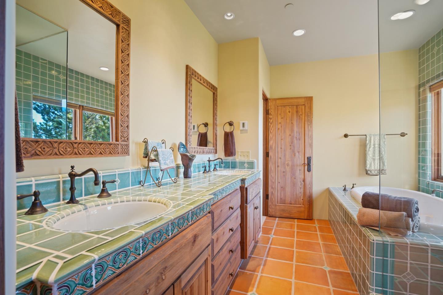 31541 Highway 1 Carmel, CA 93923 - Photo 43 of 73 a bathroom with a granite countertop sink a mirror and a shower