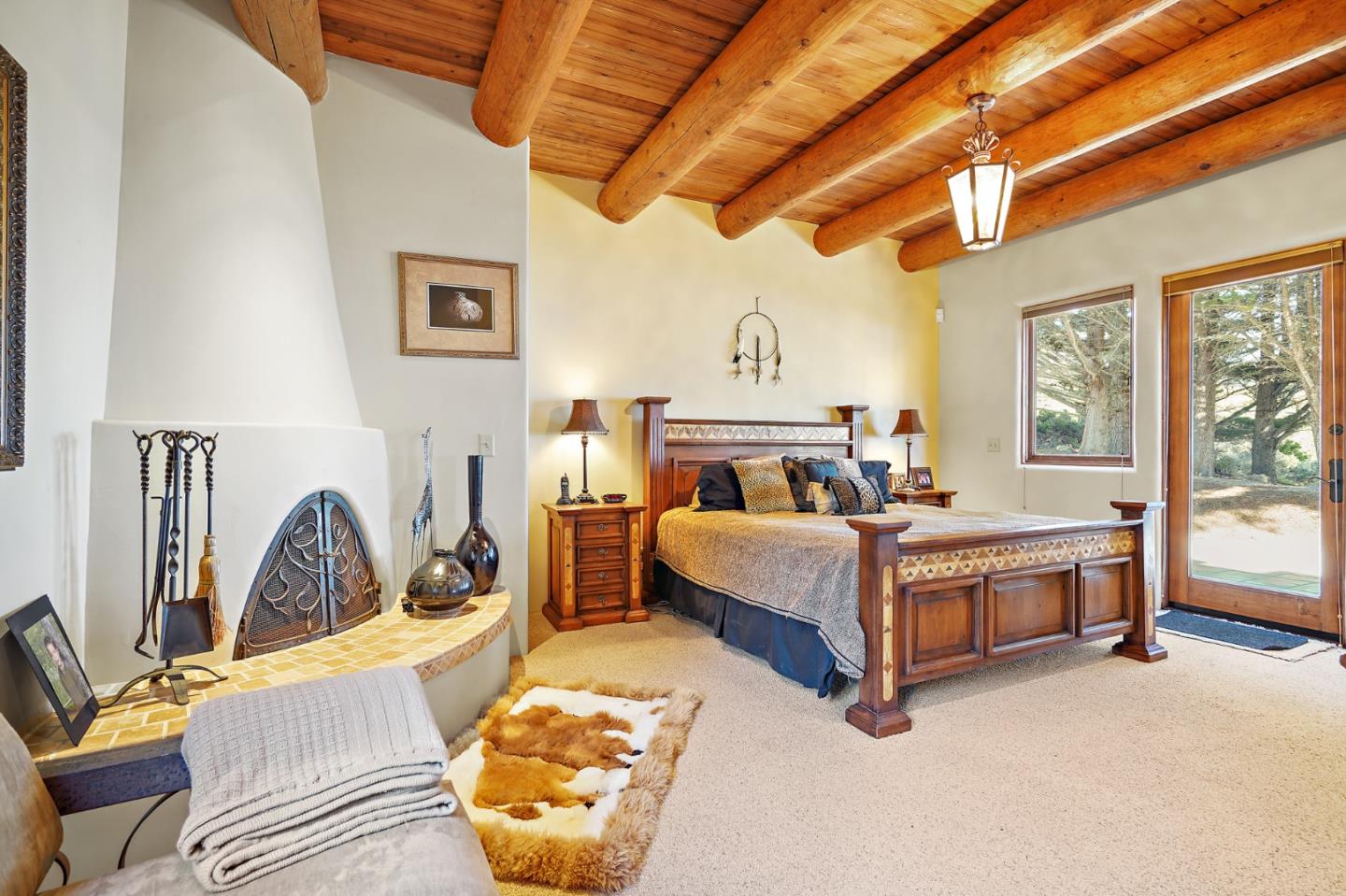 31541 Highway 1 Carmel, CA 93923 - Photo 49 of 73 a bedroom with a bed and wooden floor