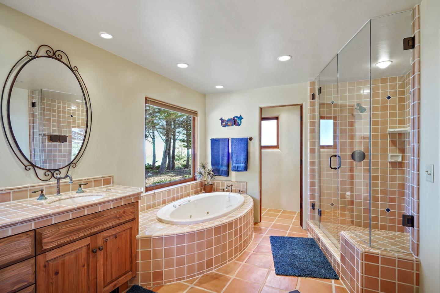 31541 Highway 1 Carmel, CA 93923 - Photo 53 of 73 a spacious bathroom with a double vanity sink a mirror and a shower