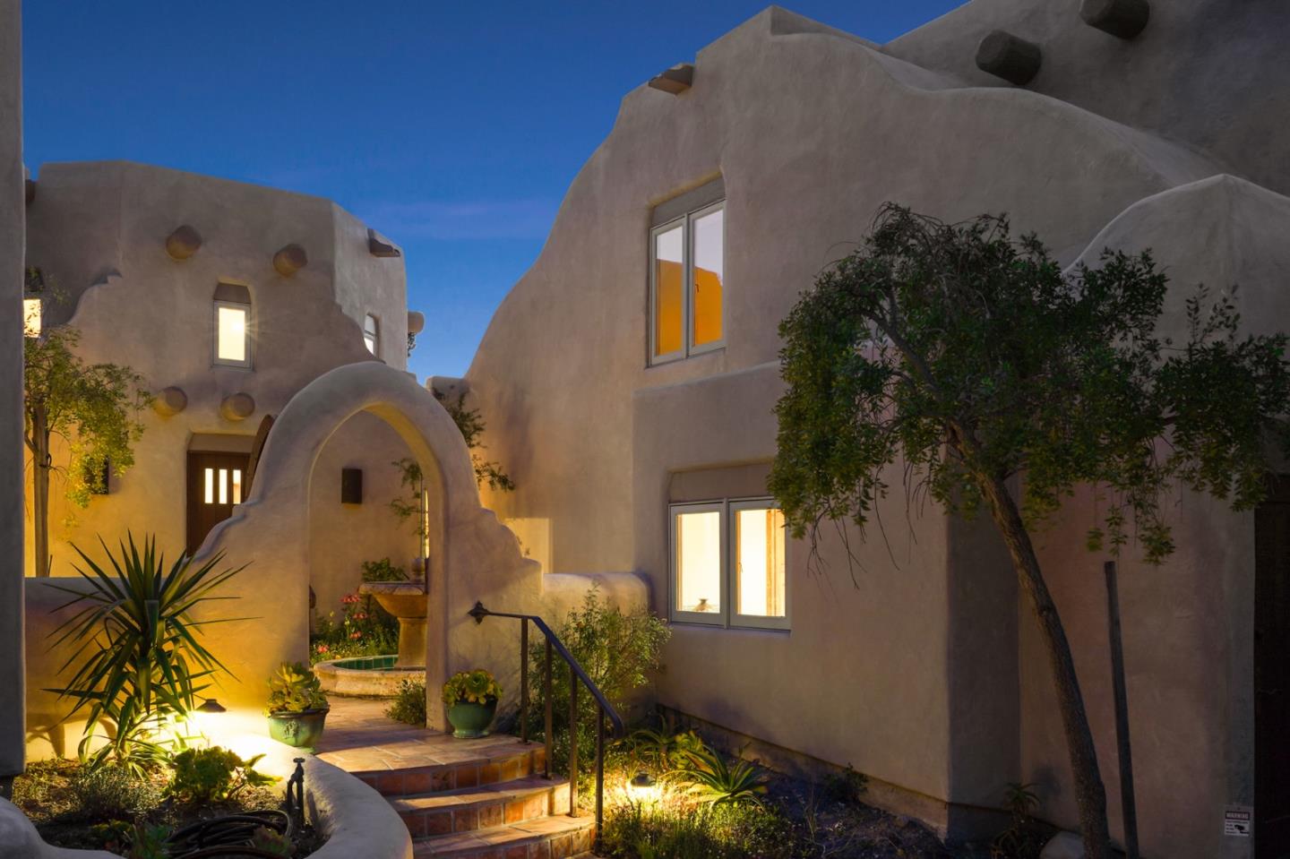 31541 Highway 1 Carmel, CA 93923 - Photo 67 of 73 a vase of flowers sitting on a table in front of a house
