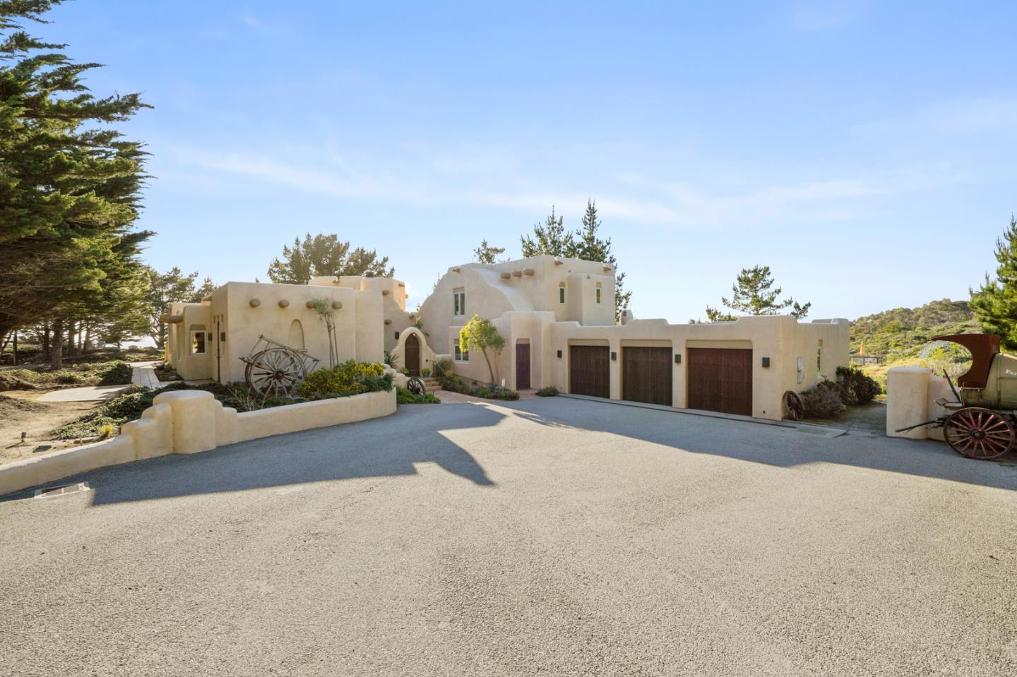 31541 Highway 1 Carmel, CA 93923 - Photo 8 of 73 a front view of a house with a yard and garage