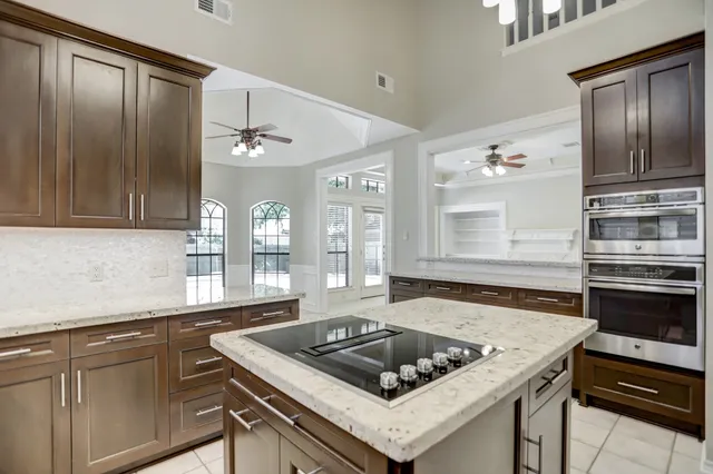 a kitchen with a stove a sink and a refrigerator
