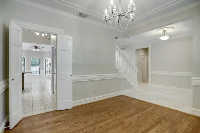 a view of a room with wooden floor and staircase
