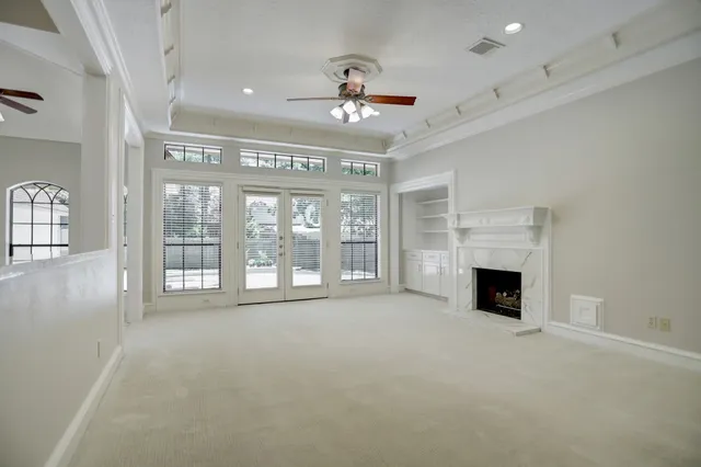 a view of an empty room with a fireplace and a window