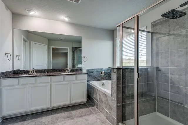 a bathroom with a tub sink and mirror