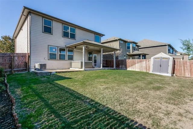 a front view of a house with a garden and yard