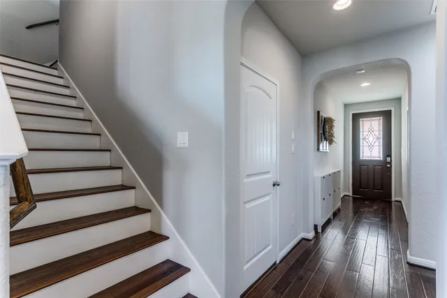 a view of a hallway with wooden floor and entryway
