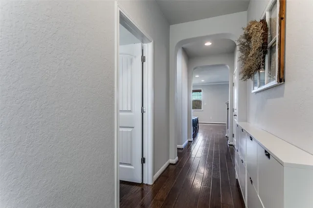 a view of a hallway with wooden floor