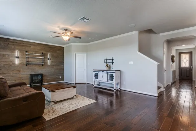a living room with furniture and wooden floor