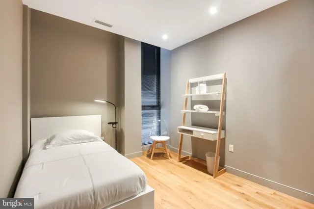 a bedroom with a bed and a lamp