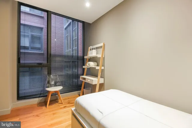 a bedroom with a bed and a window