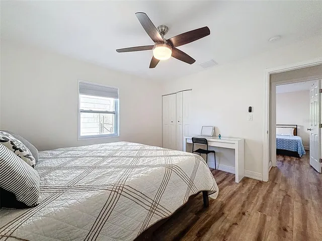 a bedroom with a bed and a chandelier