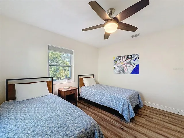 a bedroom with two beds and a window